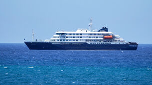 <p>The MV Hondius cruise ship is anchored at a port in Praia, Cape Verde. (AP Photo/Arilson Almeida)</p>