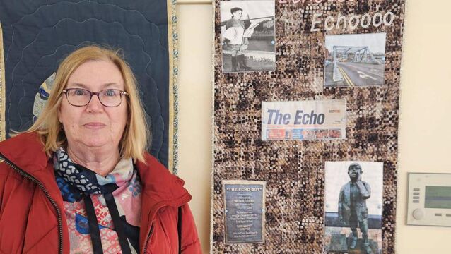 <p>Imelda O'Grady beside her patchwork quilt tribute to The Echo</p>