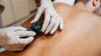 Female Doctor Examining Patients Birthmarks