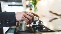 A man ringing the reception bell