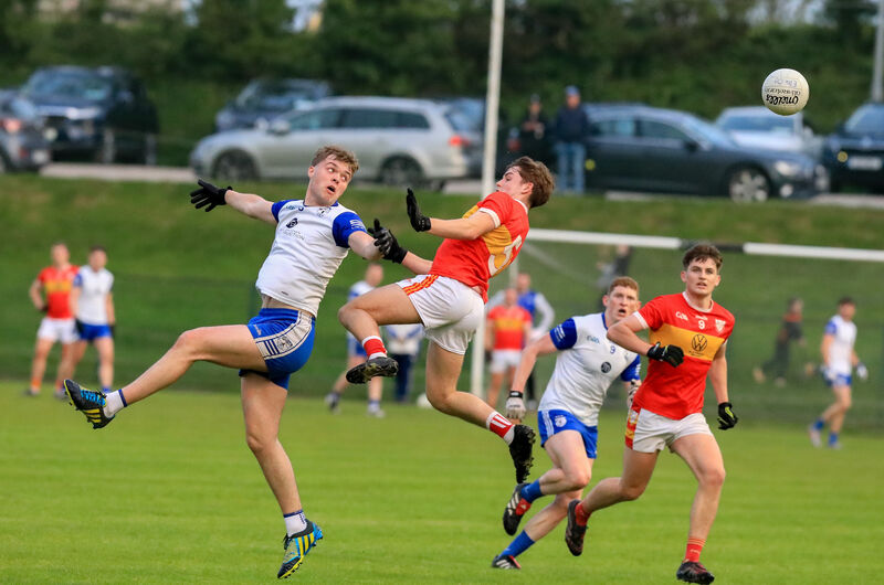 Knocknagree's Tadc O'Mahoney and Éire Óg's Colm Clifford in mid air as the ball goes past them. Picture: David Creedon