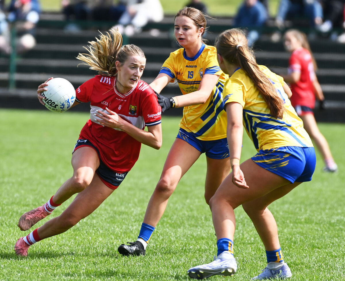 Cork's Clíona Ní Mhocháin bursting through Clare's Sheena Beirne and Naoise Talty. Picture: Eddie O'Hare