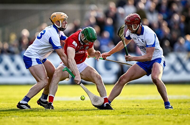 Séamus Harnedy flicks the sliotar away from Waterford players Peter Hogan and Calum Lyons. Picture: Seb Daly/Sportsfile Séamus Harnedy flicks the sliotar away from Waterford players Peter Hogan and Calum Lyons. Picture: Seb Daly/Sportsfile