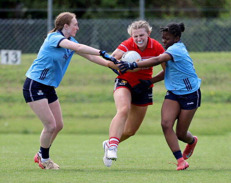  Cassandra Fitzgerald, Cork, in action against Abaigh Pollock and Charlene Sone Lenou, Dublin, in the U20 game at Cloughduv. Picture: Jim Coughlan.