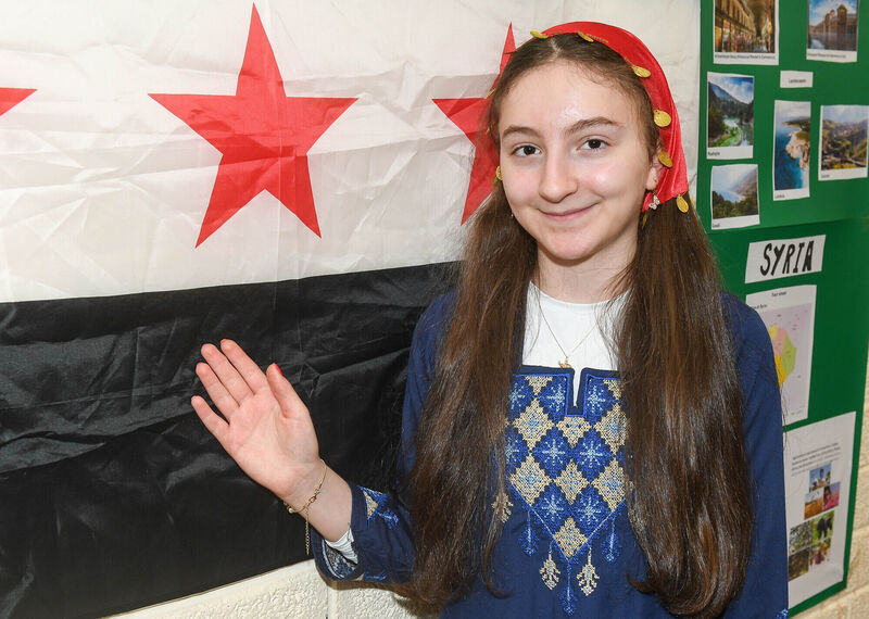 Maila Azzouzova with the flag of Syria.