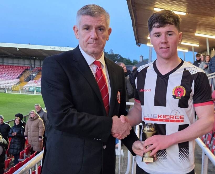 Midleton player Shay Forde receiving the Gary McCarthy Trophies Man of Man from Eddie McEvoy, Cork Youth League, at the Munster FA Turner’s Cross Stadium. 