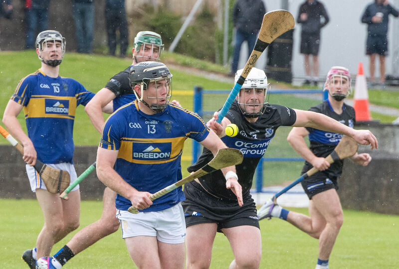 Carrigtwohill's James Mulcahy attempts to break away from Eoghan Murphy of Sarsfields. Picture: Howard Crowdy