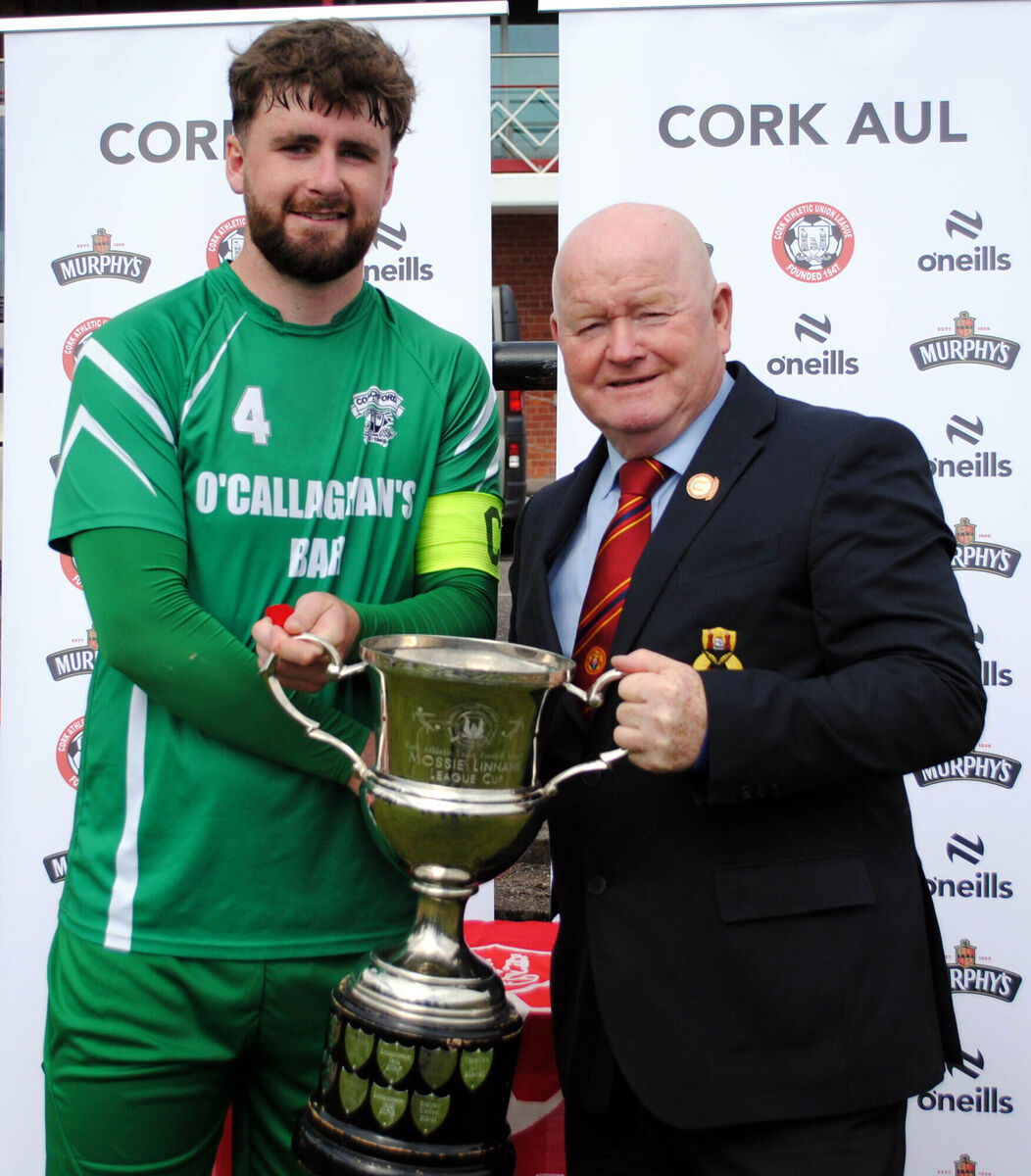 Denis Crowley (Cork AUL) presents the Mossie Linnane Cup to Coachford captain Mark Murphy. Picture: Barry Peelo.