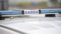 Garda sign and blue lights on a Garda car.