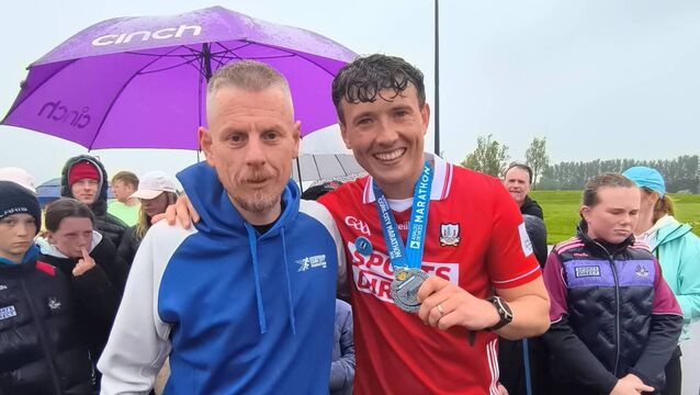 <p>Brothers Jordan and Cian Adams celebrating their latest marathon.</p>