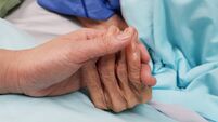 Holding grandmother's hand in the nursing care. Showing all love, empathy, helping and encouragement : healthcare in end of life