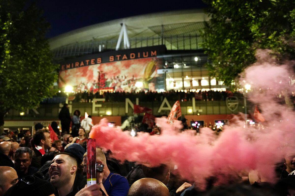 Arsenal fans celebrate with flares at the Emirates Stadium, London. Arsenal were crowned Premier League champions for the first time in 22 years after Manchester City were held to a 1-1 draw at Bournemouth. 
