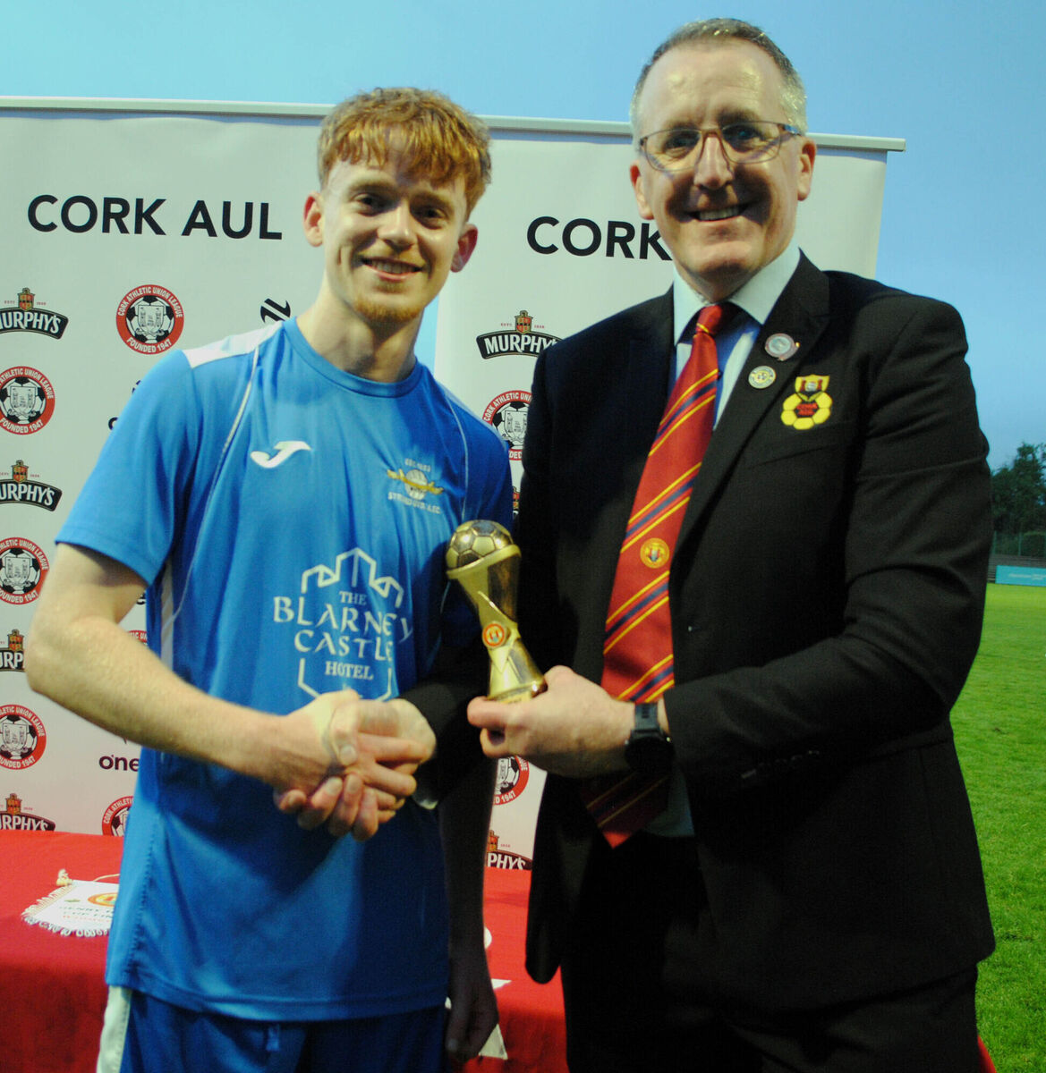 Strand A's Sean Gavin receives the man-of-the-match award (Sponsored by Gary McCarthy Trophies) from Don Cafferkey (Cork AUL). Picture: Barry Peelo. Strand A's Sean Gavin receives the man-of-the-match award (Sponsored by Gary McCarthy Trophies) from Don Cafferkey (Cork AUL). Picture: Barry Peelo.