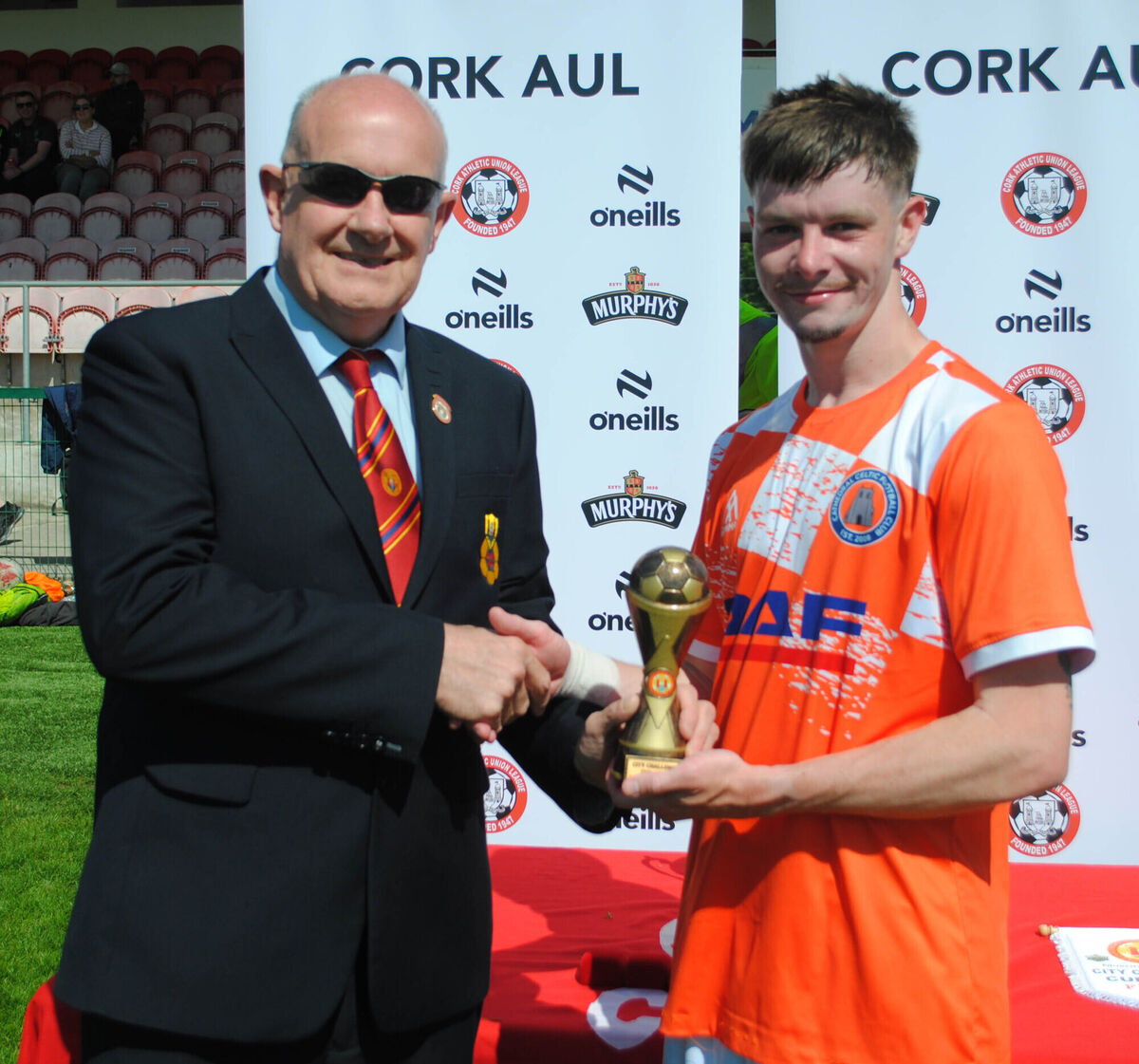 Dan O'Flynn (Cork AUL) presents the man of the match award (Sponsored by Gary McCarthy Trophies) to Cathedral Celtic's Scott O'Callaghan. Dan O'Flynn (Cork AUL) presents the man of the match award (Sponsored by Gary McCarthy Trophies) to Cathedral Celtic's Scott O'Callaghan.