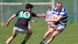<p> Oisin Whyte, Nemo Rangers, closes in on Conor Cahalane, Castlehaven, at Trabeg. Picture: Jim Coughlan.</p>