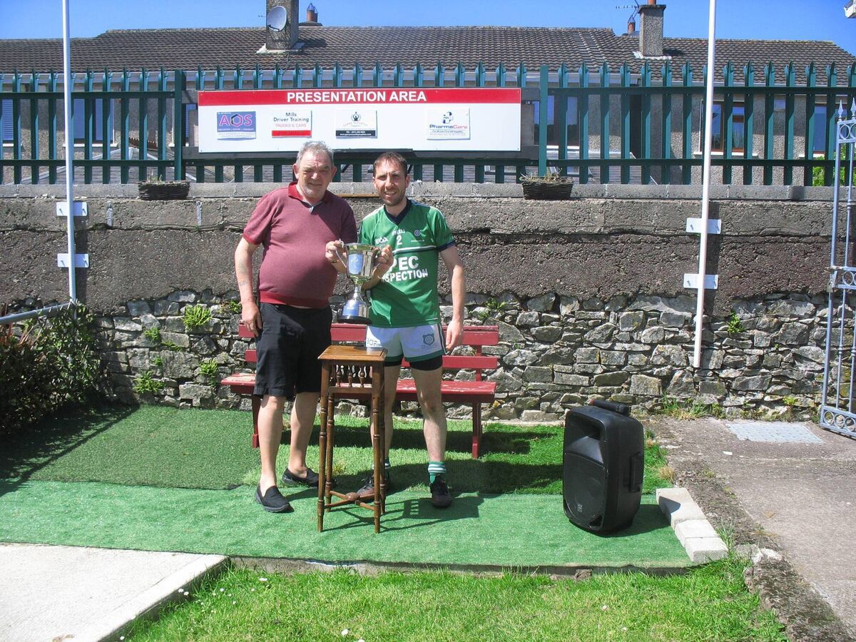 Seandún Chairman Mick Buckely presenting the trophy to White's Cross captain Richard Sherlock Seandún Chairman Mick Buckely presenting the trophy to White's Cross captain Richard Sherlock