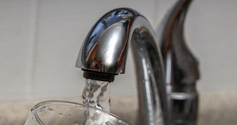 Glass at water tap and filling water with lead contamination