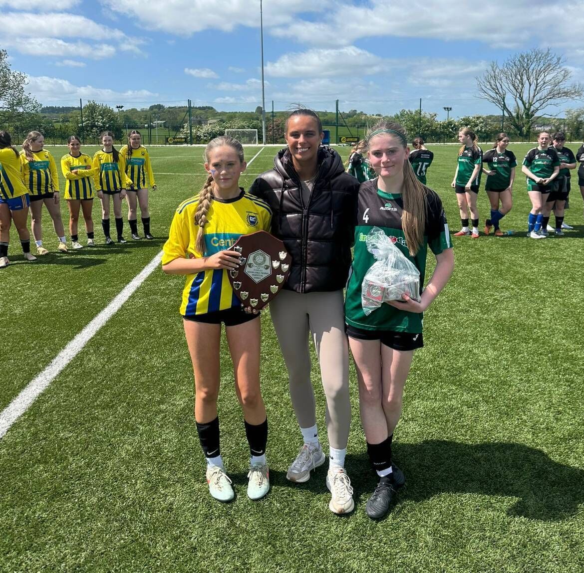 Professional footballer and former Presentation Ballyphehane student Alix Mendez presents both captains of the U15 trophy final with their trophy and medals. Buttevant captain Hazel Mortell and Pres Ballyphehane captain Aoibhe Hartnett. Professional footballer and former Presentation Ballyphehane student Alix Mendez presents both captains of the U15 trophy final with their trophy and medals. Buttevant captain Hazel Mortell and Pres Ballyphehane captain Aoibhe Hartnett.