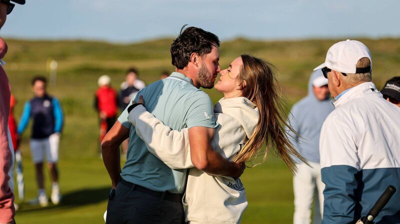 Fota Island's David Howard celebrates with his girlfriend Gabby Koumrack after sealing victory on Sunday in the East of Ireland Men's Amateur Open at Baltray. Pic: Bryan Keane, Inpho