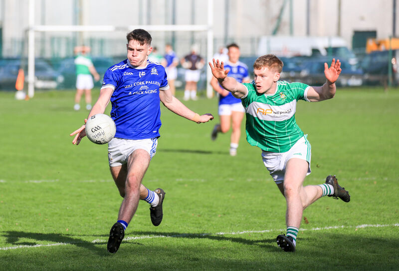 Aghabullogue's Paul Ring tries to block a shot from Naomh Abán's Ed Myers last year. Picture: David Creedon