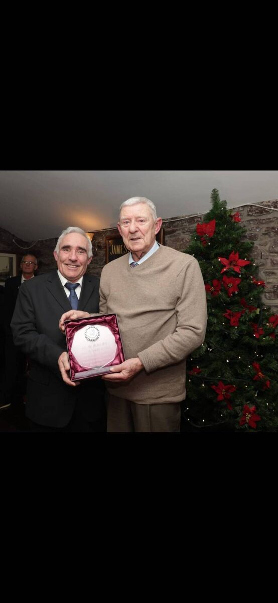 Tony Thompson presents the Pat McAuliffe Hall of Fame Award to referee Barry Kearney at the Kiln in Heineken Brewery recently