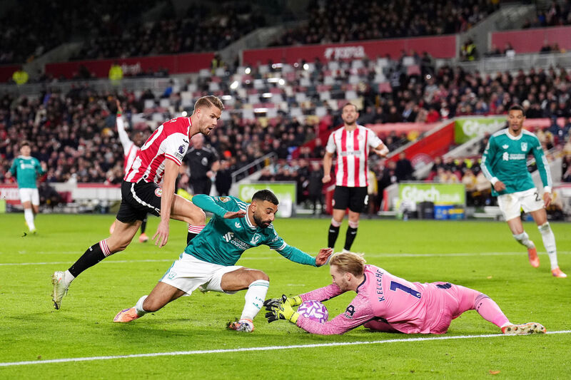 Brentford goalkeeper Caoimhin Kelleher saves from Liverpool's Mohamed Salah during the Premier League match at the Gtech Community Stadium, London. Picture: John Walton/PA Wire. Brentford goalkeeper Caoimhin Kelleher saves from Liverpool's Mohamed Salah during the Premier League match at the Gtech Community Stadium, London. Picture: John Walton/PA Wire.