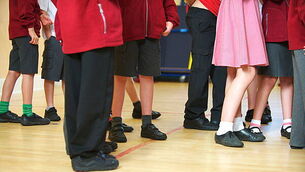 DNHJR2 Primary or first school children at their school waiting for assembly