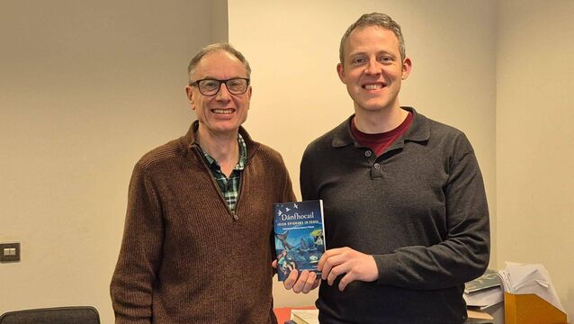 <p>Aidan Doyle and Ken Ó Donnchú, lecturers at UCC, with their book, Dánfhocail: Irish Epigrams In Verse</p>