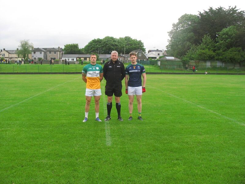 Referee Cormac Dineen, accompanied by captains Vinny Keating (Delanys) and Aidan Roche (Glanmire) Referee Cormac Dineen, accompanied by captains Vinny Keating (Delanys) and Aidan Roche (Glanmire)