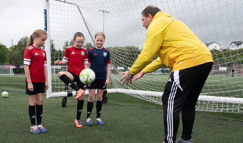 Head of Coaching Denis Behan giving tips on football skills to CWSSL Academy Girls Isabelle Kiely, Muireann Louadah and Aisling Behan at the launch of the CWSSL Coerver Coaching summer camps. Picture: Howard Crowdy
