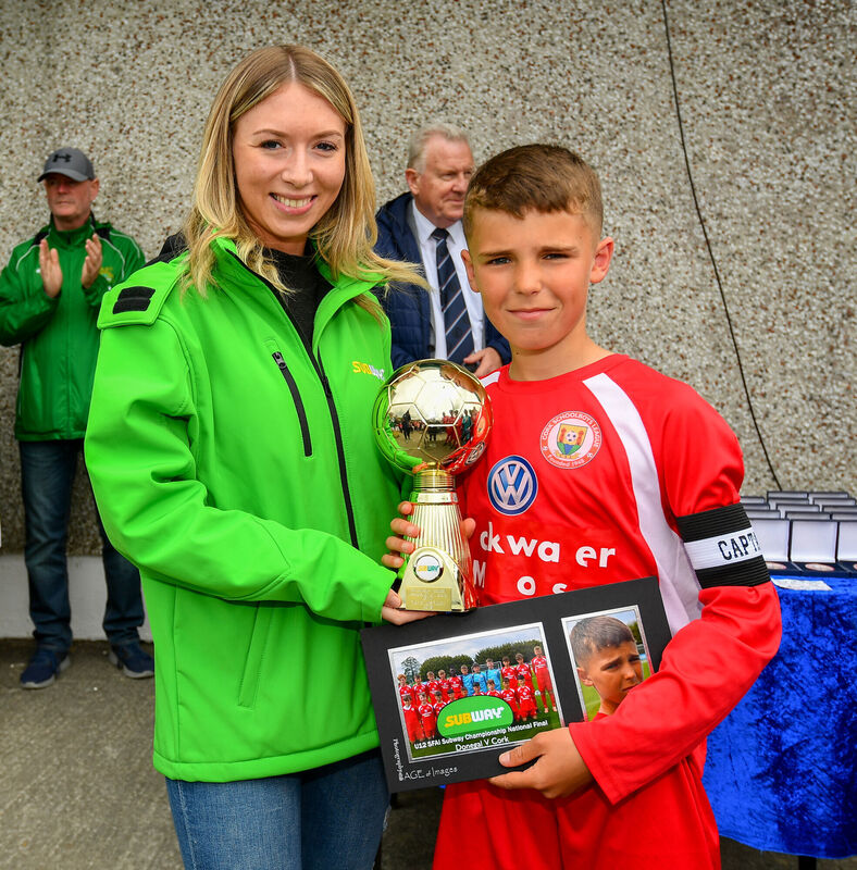Matthew Moore of Cork receives the Man of the match award from Kirby Axon, Marketing Executive, Subway, following the Under 12 SFAI Subway Championship Final match between Donegal and Cork at Mullingar Athletic in Gainstown, Westmeath. Photo by Ramsey Cardy/Sportsfile Matthew Moore of Cork receives the Man of the match award from Kirby Axon, Marketing Executive, Subway, following the Under 12 SFAI Subway Championship Final match between Donegal and Cork at Mullingar Athletic in Gainstown, Westmeath. Photo by Ramsey Cardy/Sportsfile