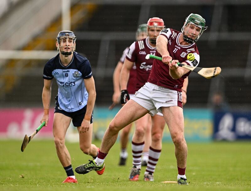 Cathal Mannion of Galway shoots as Brian Hayes of Dublin closes in. Picture: Piaras Ó Mídheach/Sportsfile