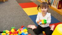 Toddler is Playing With Blocks At the Library