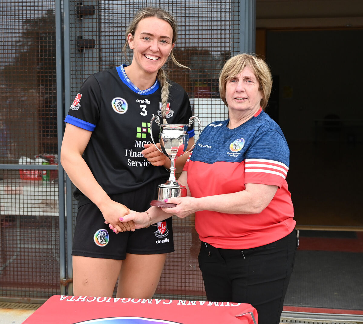 Mary McSweeney presents the trophy to Sarsfields captain Katie Barry. Picture: Eddie O'Hare Mary McSweeney presents the trophy to Sarsfields captain Katie Barry. Picture: Eddie O'Hare