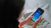 Asian woman using ai apps on bed