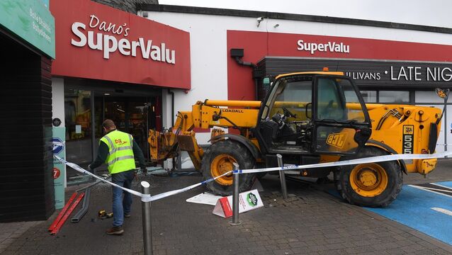 <p>Scene at SuperValu Mallow, Co. Cork after a JCB was used in an attempt to remove an ATM from the building. Picture: Michael Mac Sweeney</p>