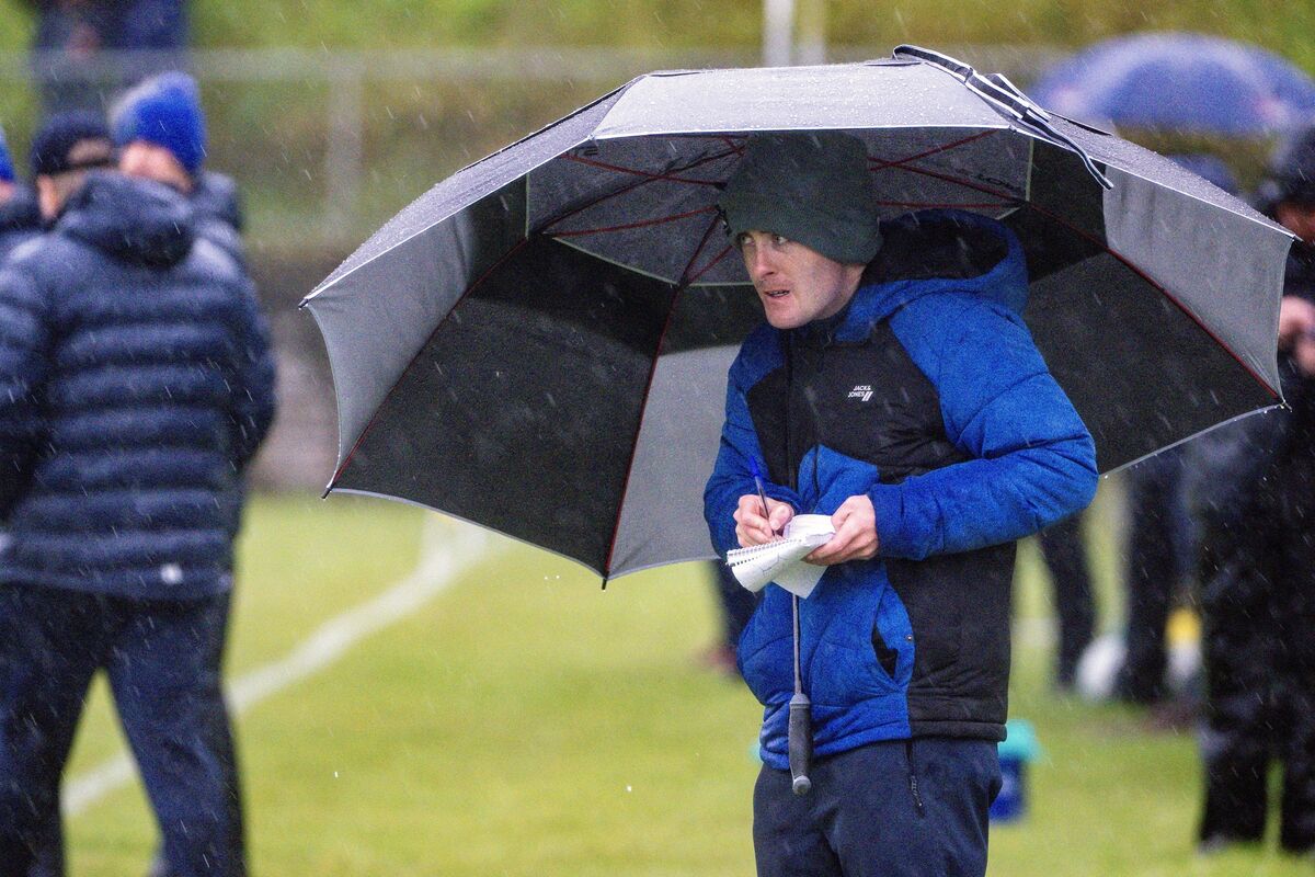 Echo sports writer Barry O’Mahony takes refuge beneath an umbrella as torrential rain falls in Rosscarbery. Picture: Chani Anderson Echo sports writer Barry O’Mahony takes refuge beneath an umbrella as torrential rain falls in Rosscarbery. Picture: Chani Anderson