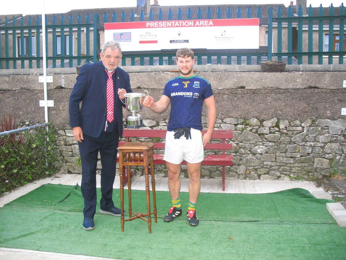 Mick Buckley presents the trophy to Glanmire captain John Kelleher Mick Buckley presents the trophy to Glanmire captain John Kelleher