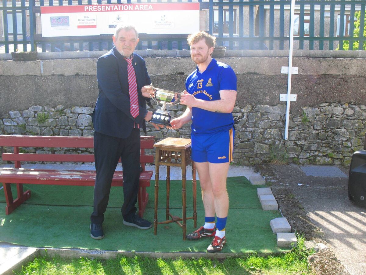 Seandún Chairman Mick Buckley presents the trophy to St Finbarr's Ruairí O'Connor Seandún Chairman Mick Buckley presents the trophy to St Finbarr's Ruairí O'Connor