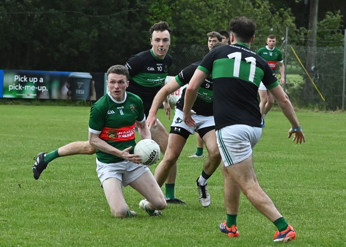 Clon's Dara Ó Sé manages to pass as he is surrounded by the Nemo Rangers trio of Oisin Whyte, Brian Murphy and Ronan Dalton. Picture: Martin Walsh. Clon's Dara Ó Sé manages to pass as he is surrounded by the Nemo Rangers trio of Oisin Whyte, Brian Murphy and Ronan Dalton. Picture: Martin Walsh.
