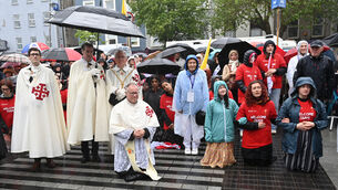 <p> 7th June 2026 .... Kneeling in prayer during the wet weather at the centenary year Eucharistic procession in Cork. Picture:Eddie O'Hare</p>