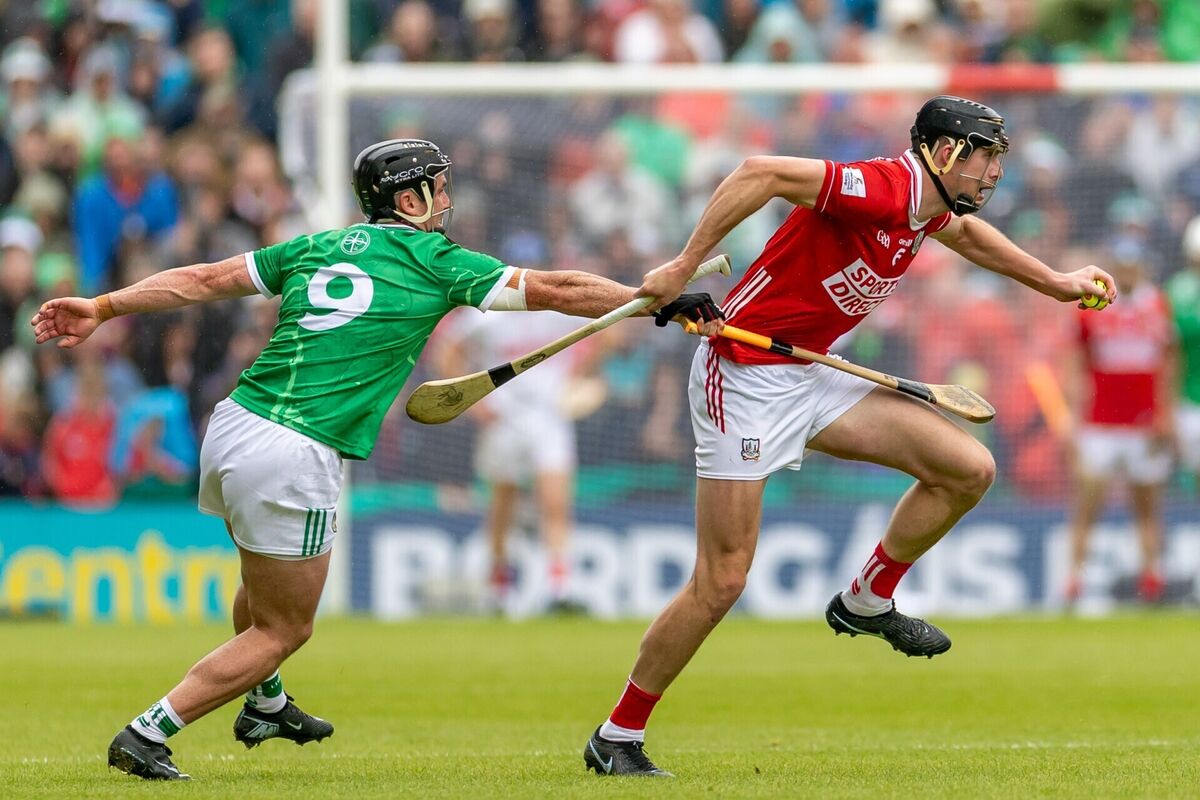 Robert Downey carries the sliotar out past Darragh O'Donovan of Limerick. Picture: INPHO/Morgan Treacy