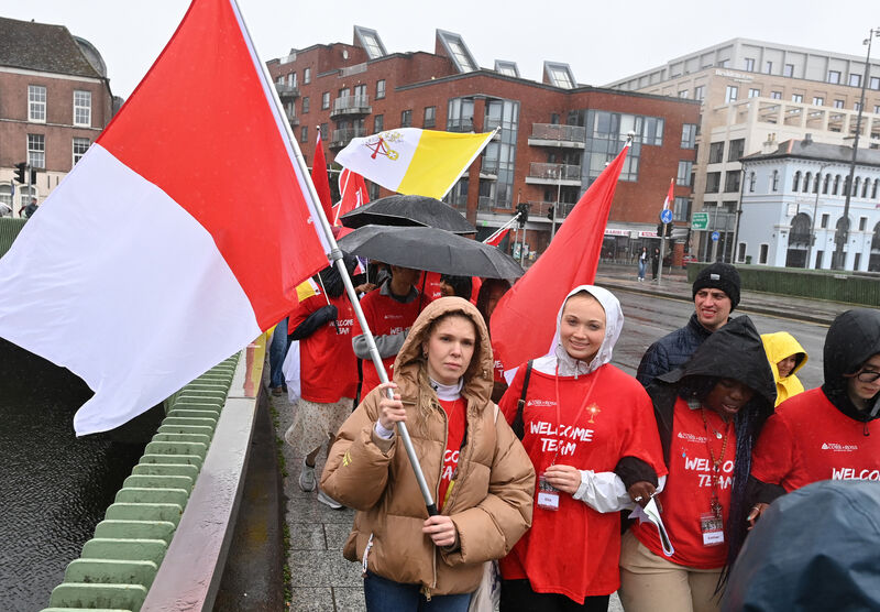 Braving the wet weather during the centenary year Eucharistic procession in Cork. Braving the wet weather during the centenary year Eucharistic procession in Cork.