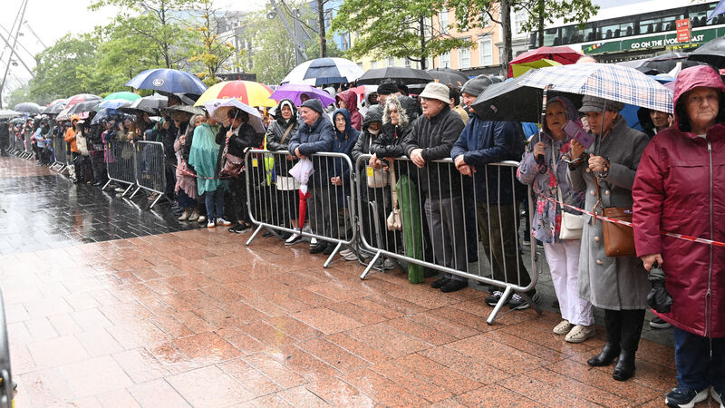 A section of the large crowd who braved the wet weather during the centenary year Eucharistic procession. A section of the large crowd who braved the wet weather during the centenary year Eucharistic procession.