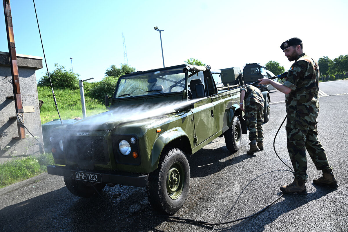 Soldiers cleaning an old Landrover Defender used for ceremonial events and funeral corteges Soldiers cleaning an old Landrover Defender used for ceremonial events and funeral corteges