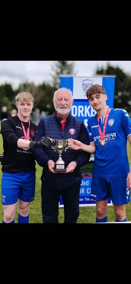 Corkbeg co-captains Jamie Walsh and Jago Evan’s been presented with the Daly Industrial Supplies U18 League 3 Cup by the Cork Youth League Mr Sean O’Sullivan recently. KD Corkbeg co-captains Jamie Walsh and Jago Evan’s been presented with the Daly Industrial Supplies U18 League 3 Cup by the Cork Youth League Mr Sean O’Sullivan recently. KD