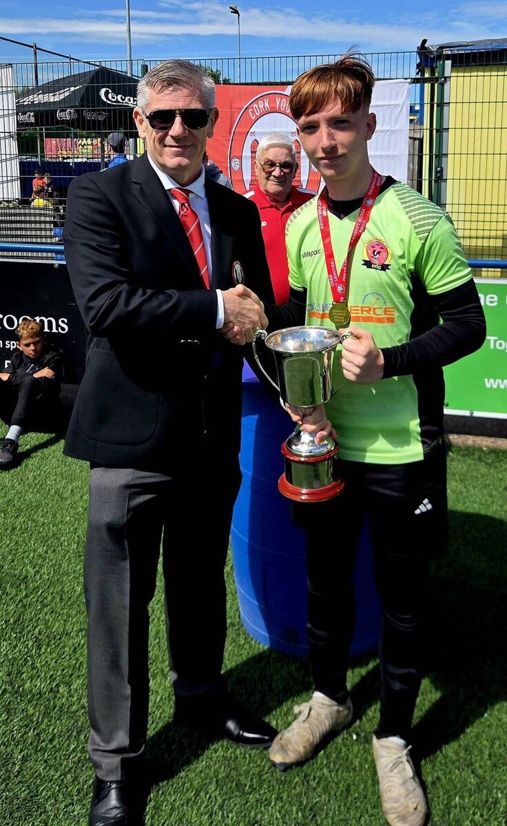 Eddie McEvoy from the Cork Youth League presenting the Daly Industrial Supplies U17 Premier League Cup to Midleton captain Jack Mills after his side best Douglas Hall at Moneygourney recently. KD Eddie McEvoy from the Cork Youth League presenting the Daly Industrial Supplies U17 Premier League Cup to Midleton captain Jack Mills after his side best Douglas Hall at Moneygourney recently. KD
