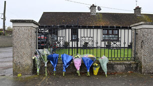 <p> Flowers at the residence on Rockview Terrace, Doneraile, Co Cork, where the body of postman Barry Daly was found last October. Picture: Dan Linehan.</p>