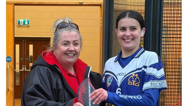 <p>Grainne O'Leary, Inniscarra captain is presented with the Barry O'Sullivan trophy by Mairead Lynch, Cork Camogie Board Development officer.</p>