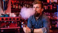 Vape. Vaping man in a cloud of vapor. Photo is taken in a vape bar